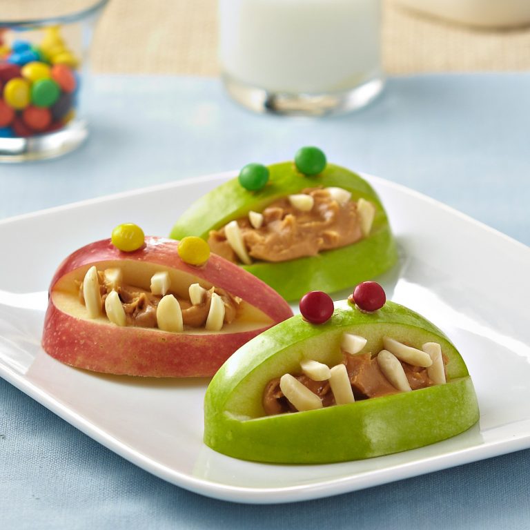 Monster apple bites with peanut butter and almond teeth