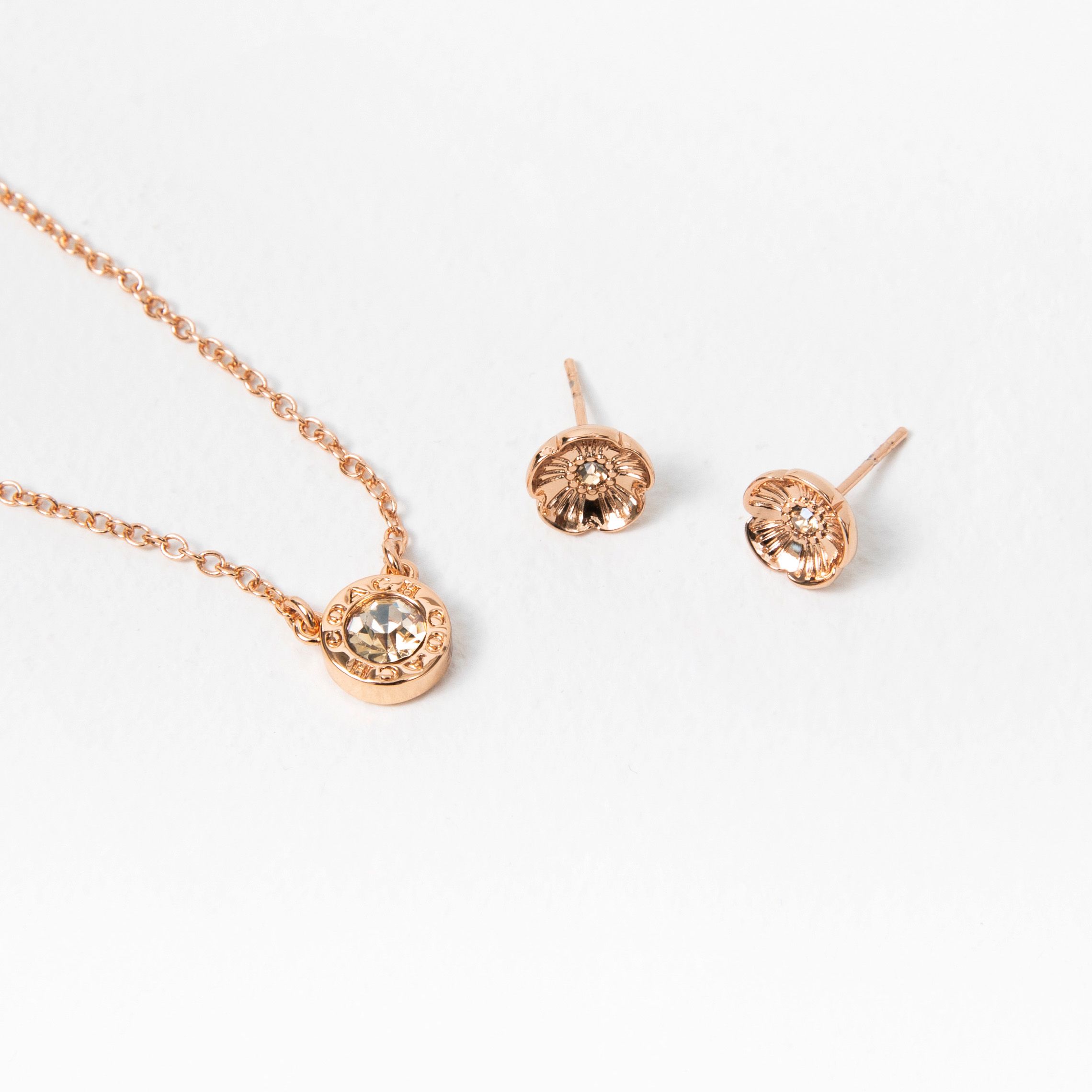 coach rose gold flower earrings and necklace set