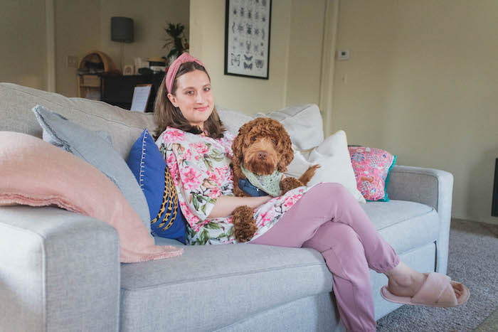 girl with dog on couch wearing robe and slippers from fabfitfun