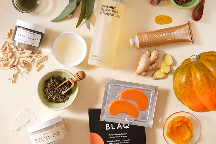 Beauty products on a counter with pumpkin and other fall-inspired items