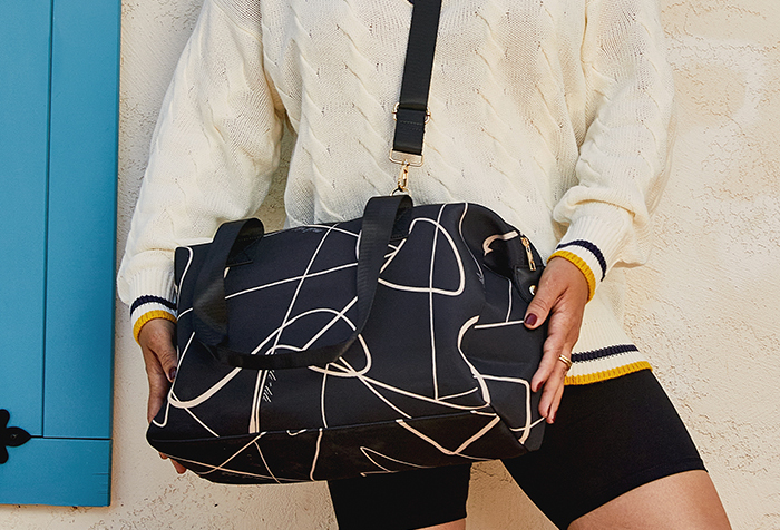 Close up image of Mali and Lili black weekender bag