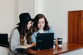 Two girls looking at computer together