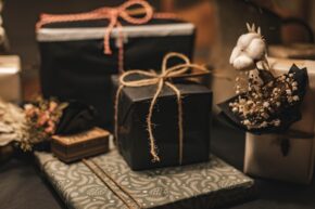 Wrapped gifts on a table in black wrapping paper