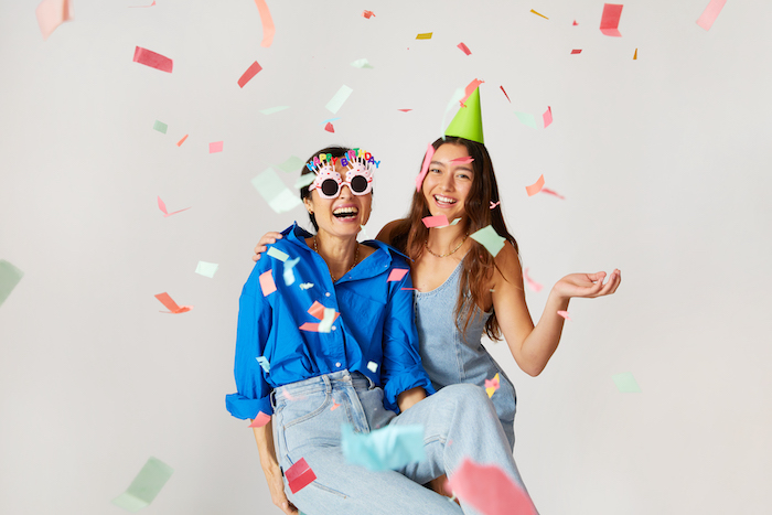 Two girls pictured as part of a birthday celebration with confetti