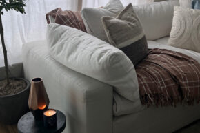 white couch with little korboose throw blanket next to table with lit candle